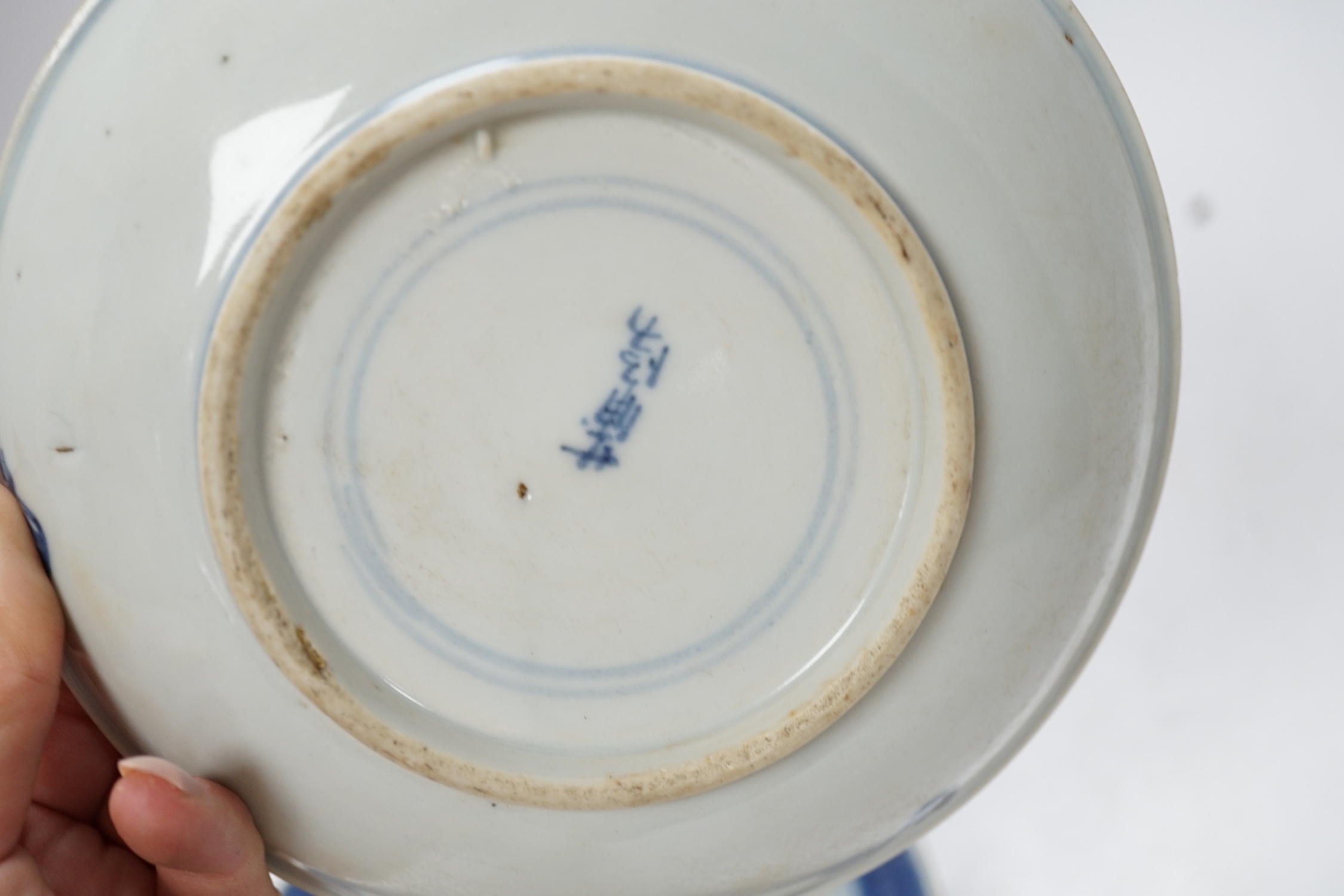 A group of 18th/19th century Chinese blue and white saucers and shallow dishes, largest 18cm in diameter. Condition - varies, mostly fair